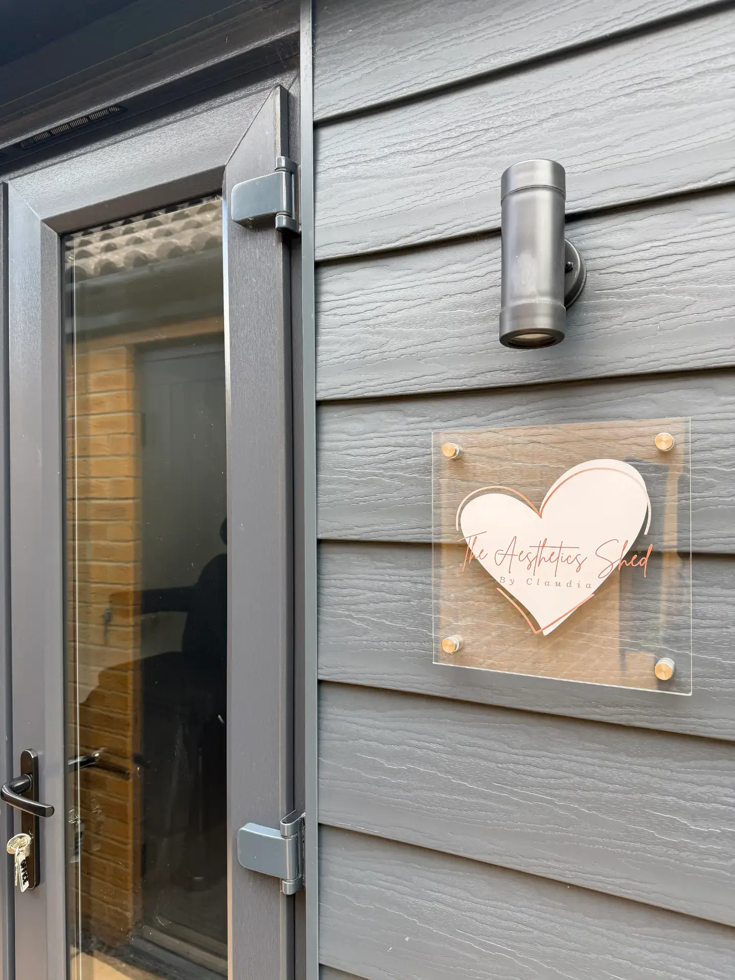 The clinic entrance and logo sign at The Aesthetics Shed by Claudia in Banbury